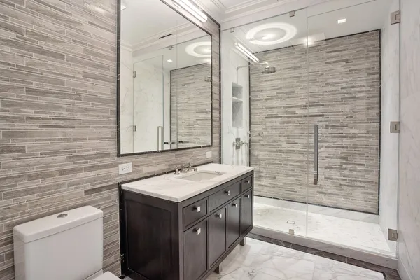 a kitchen with granite countertop white cabinets and stainless steel appliances
