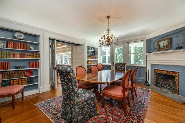 a view of a dining room with furniture a rug and wooden floor