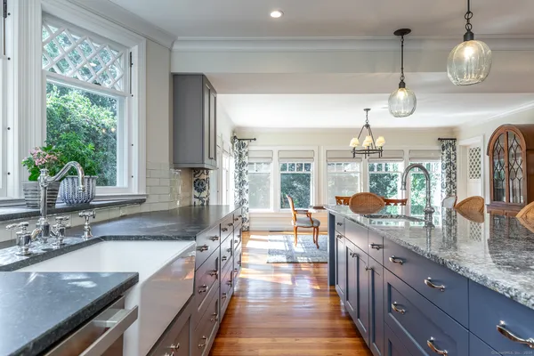 a large kitchen with granite countertop a sink and a large window
