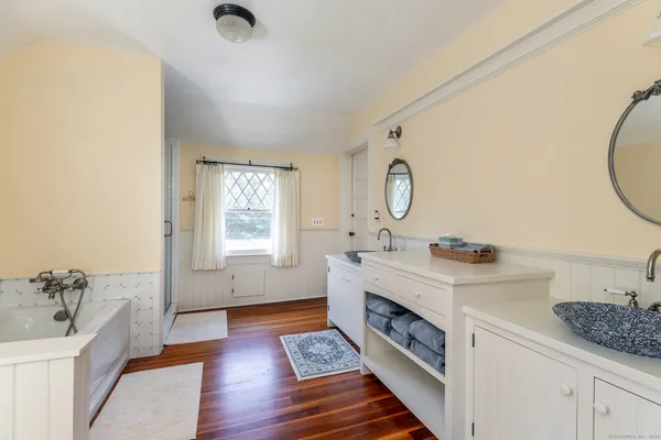 a spacious bathroom with double vanity and a mirror