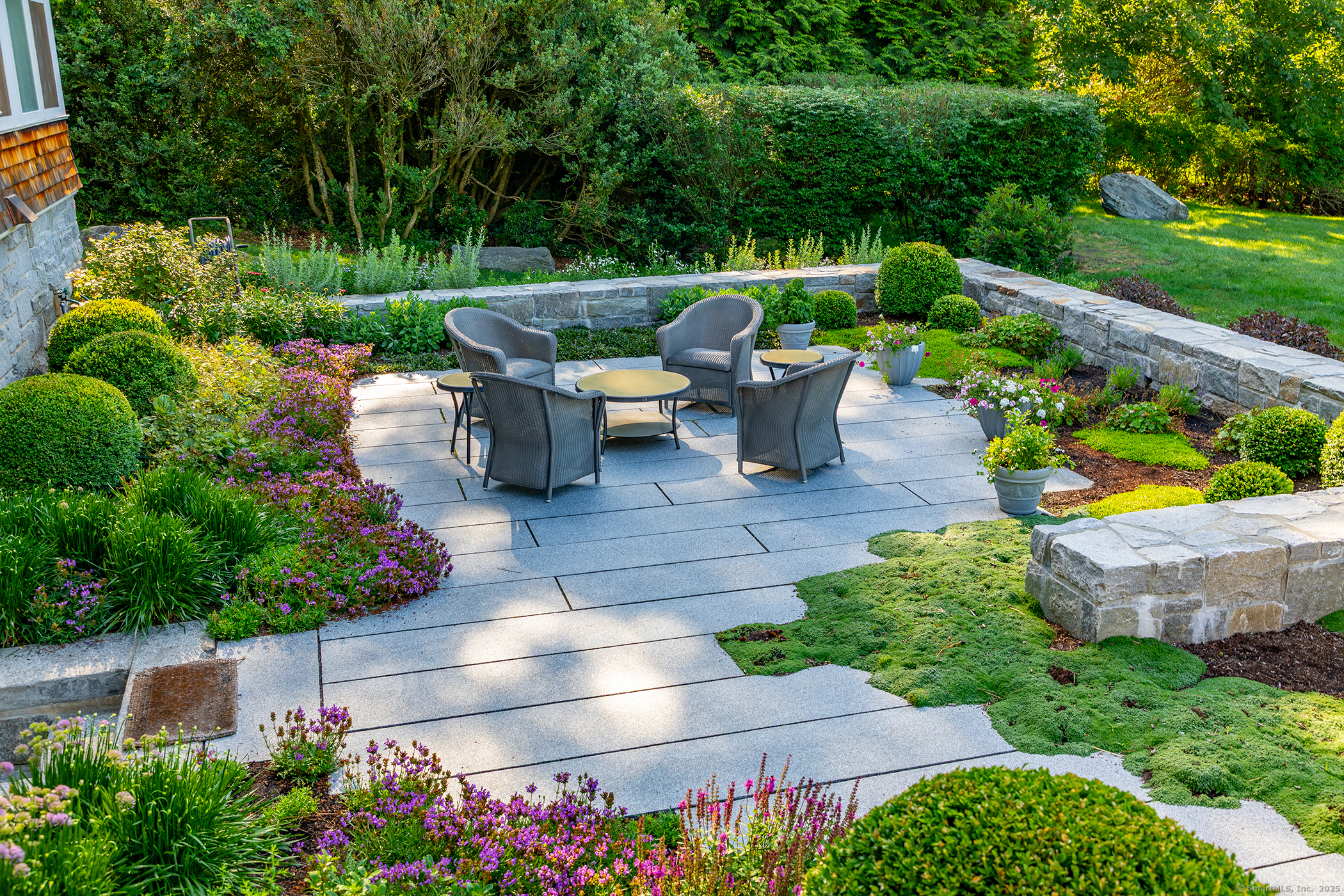 51 Ferry Bridge Road Washington, CT 06793 - Photo 34 of 36 a view of a patio with couches table and chairs potted plants and large tree
