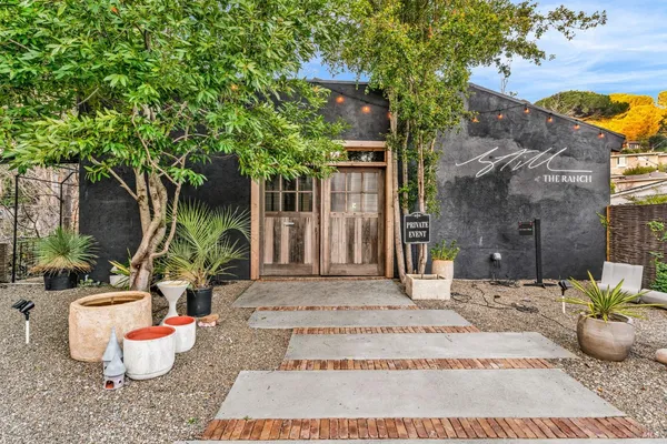 a view of a patio with couches and potted plants