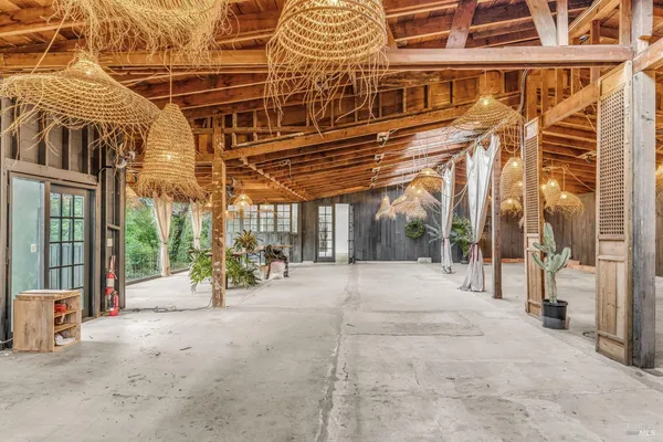 a view of a patio with table and chairs and potted plants