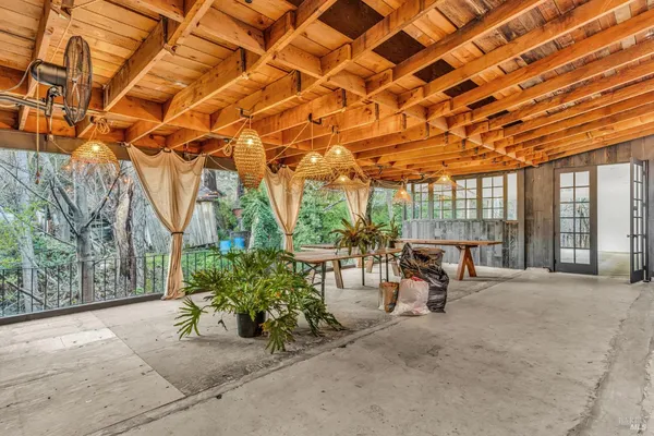 a view of a patio with a table and chairs