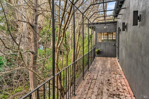a view of a patio with a table and chairs under an umbrella