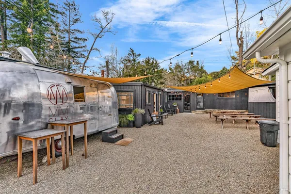 a building outdoor space with patio furniture and potted plants