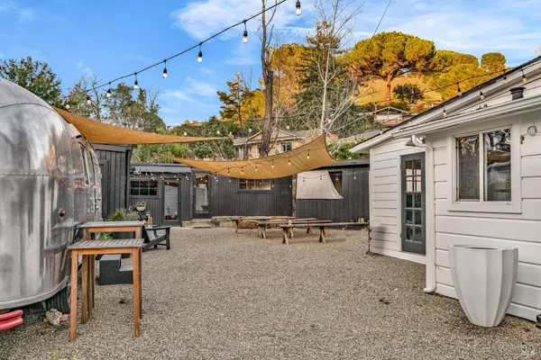 a backyard of a house with table and chairs