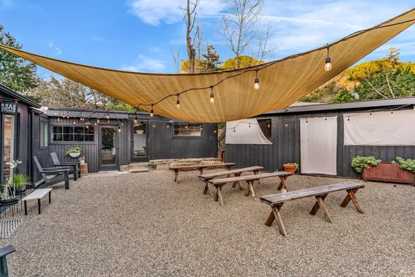 a front view of a house with plants
