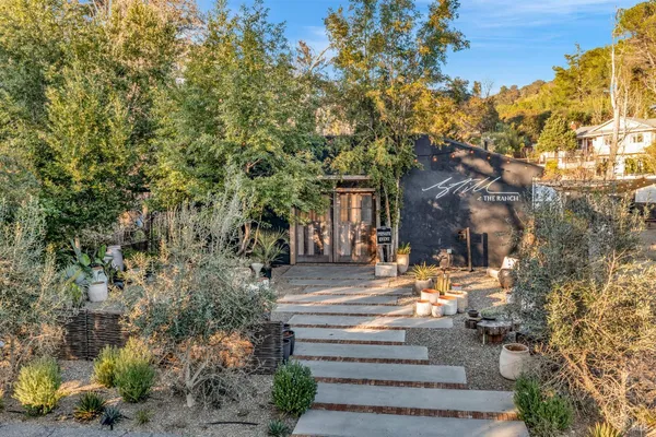 a front view of a house with garden