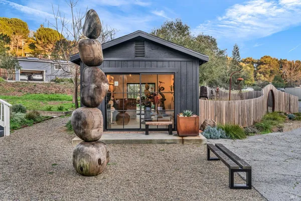 a view of a chairs and table in backyard