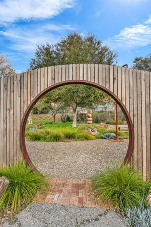 a view of a garden with a wooden fence