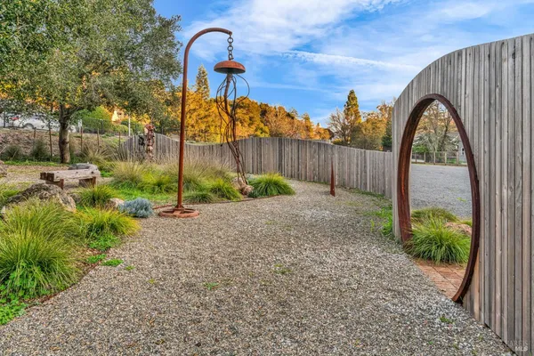 a view of a backyard with plants and outdoor seating