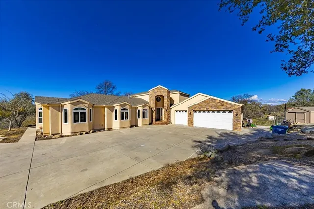 a bathroom with a granite countertop sink a mirror and a toilet