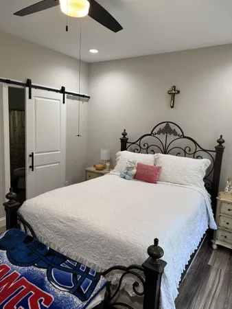 a bedroom with a bed and a chandelier