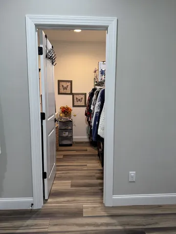 a view of a hallway with closet and stairs
