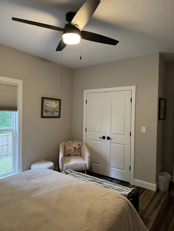 a bedroom with a large bed and a chandelier