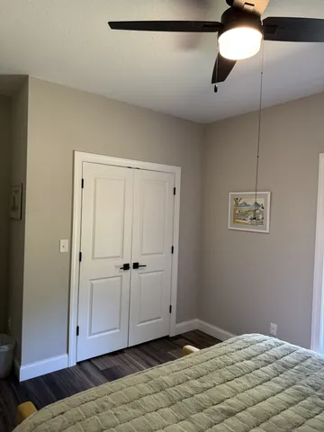 a bedroom with a bed and a chandelier