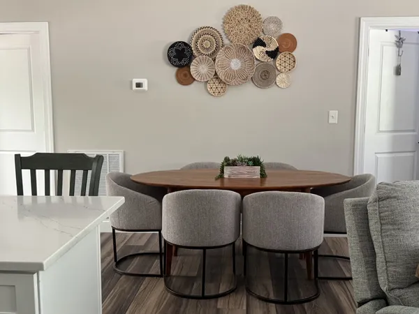 a view of a dining room with furniture and chandelier