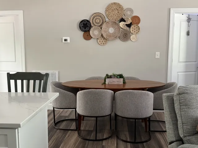 a view of a dining room with furniture and chandelier