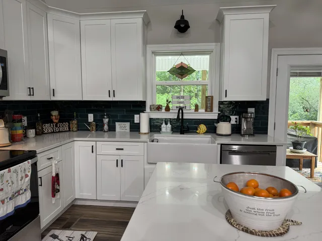 a kitchen with appliances a sink and a window