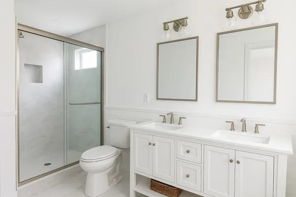 a bedroom with a large bed and a flat tv screen on dresser