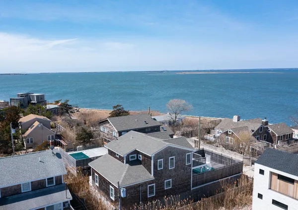 an aerial view of a house with ocean view