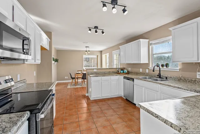 a kitchen with a sink stainless steel appliances and cabinets