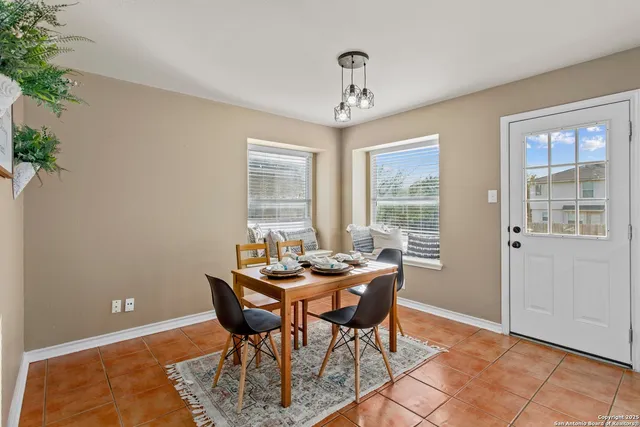a dining room with furniture and window