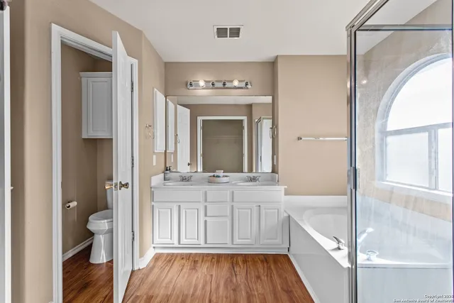 a bathroom with a vanity mirror and a bathtub