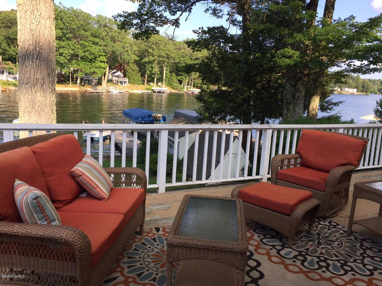 77 North Gate Island Road Otis, MA 01029 - Photo 2 of 25 a balcony with wooden floor and outdoor seating