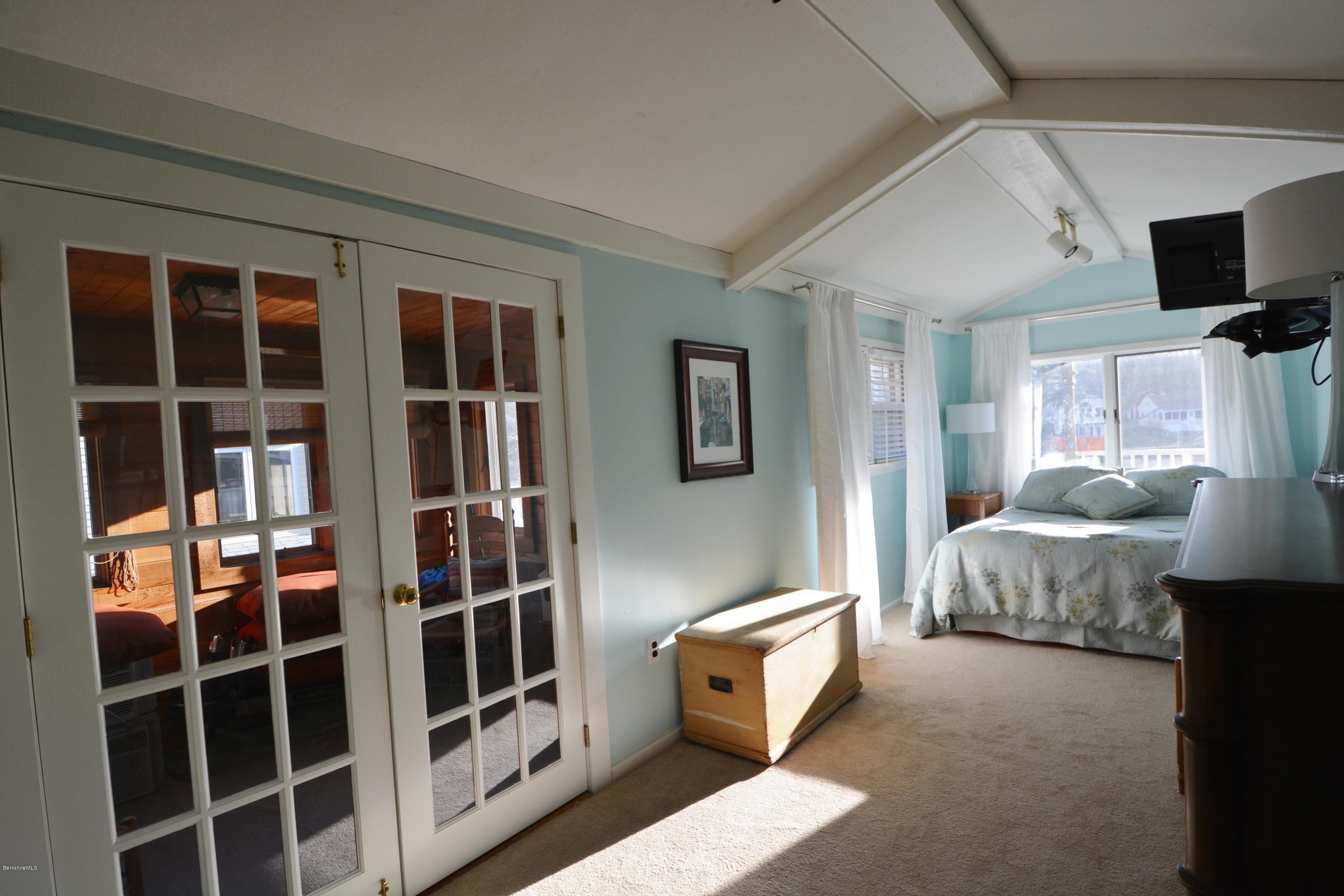 77 North Gate Island Road Otis, MA 01029 - Photo 17 of 25 a spacious bedroom with a bed and wooden floor