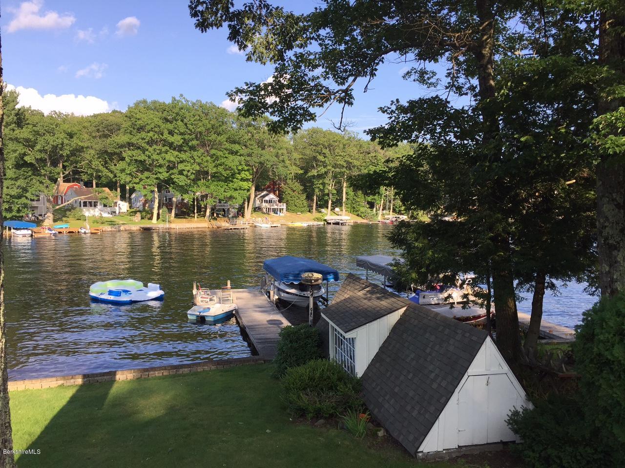 77 North Gate Island Road Otis, MA 01029 - Photo 3 of 25 a view of a lake with couches and city view