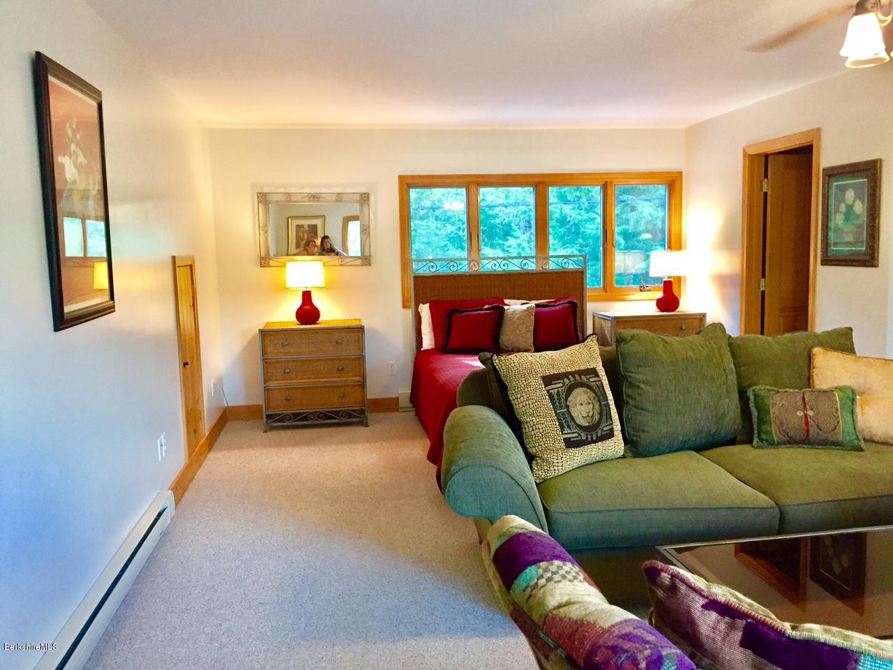 77 North Gate Island Road Otis, MA 01029 - Photo 22 of 25 a living room with furniture and a floor to ceiling window