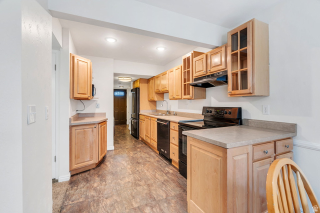 3221 North Shadowbrook Circle Provo, UT 84604 - Photo 5 of 29 Kitchen with glass fronted cabinets, black appliances, light countertops, light wood finish cabinets, and recessed lighting