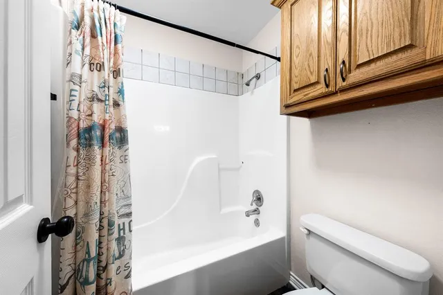 a bathroom with a shower curtain and a sink
