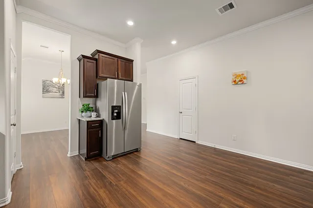 a view of kitchen with wooden floor and electronic appliances