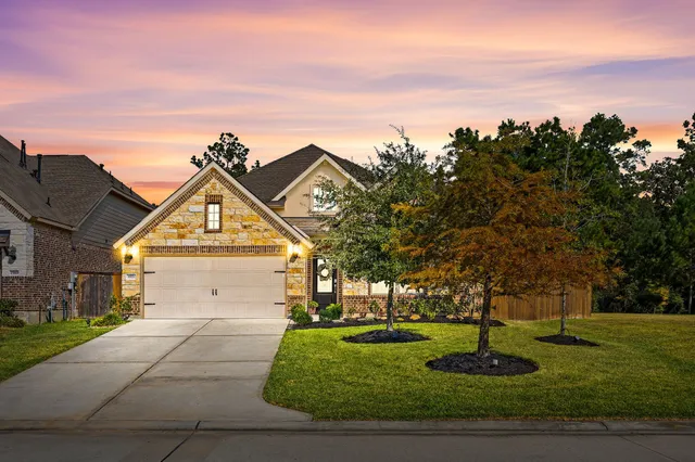 a view of a big house with a big yard and potted plants