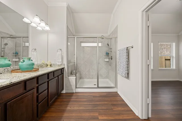 a bathroom with a double vanity sink and mirror