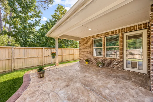a view of a backyard with a wooden fence