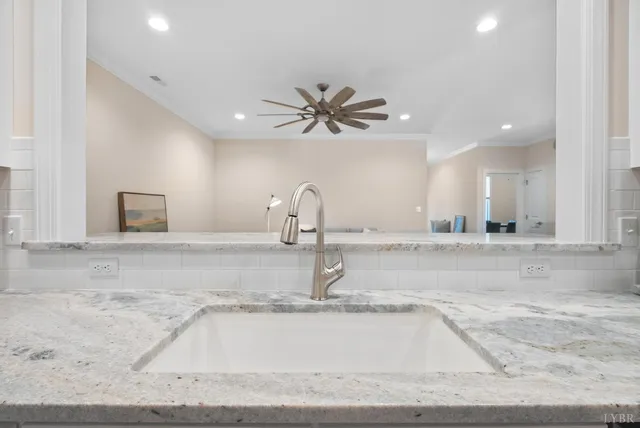 a kitchen with a sink and white cabinets