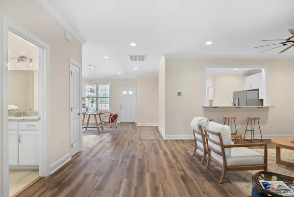 a living room with furniture and a wooden floor