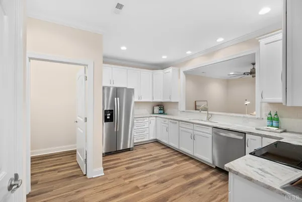 a kitchen with granite countertop a refrigerator and a sink