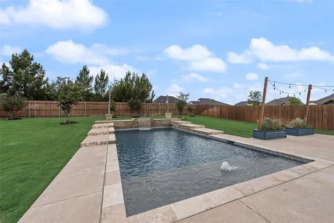 a view of a swimming pool with a yard