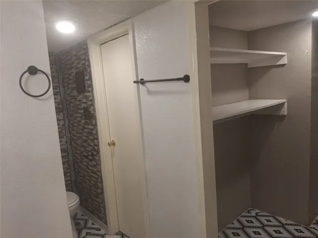 a bathroom with a glass shower door