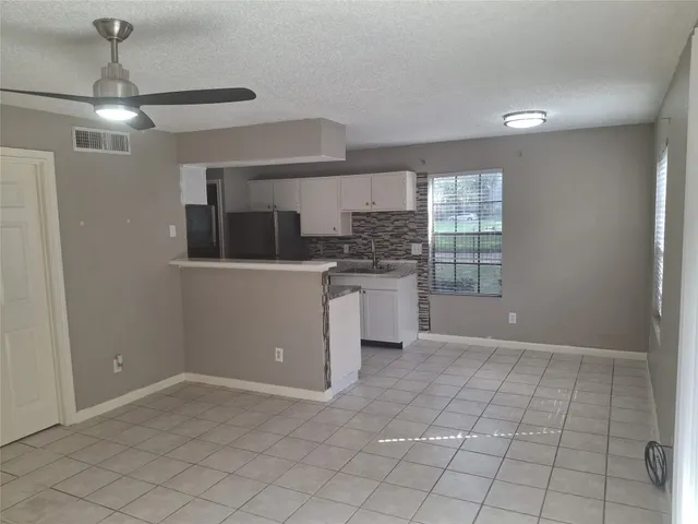 a view of a kitchen with a sink and dishwasher cabinets