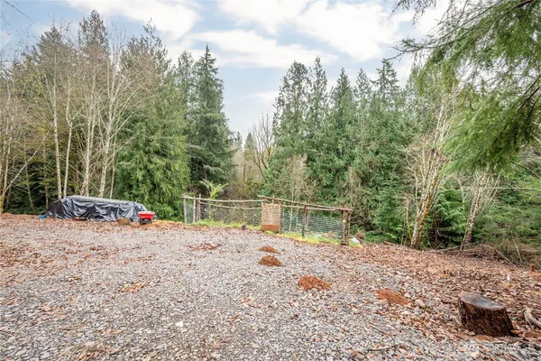 a view of a lake with beach and trees around