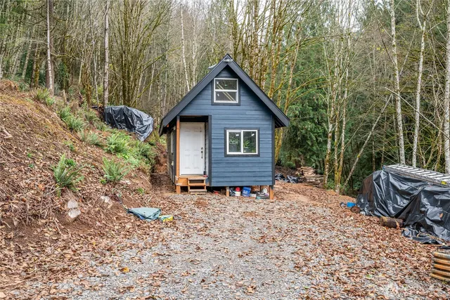 a view of a house with a yard and sitting area