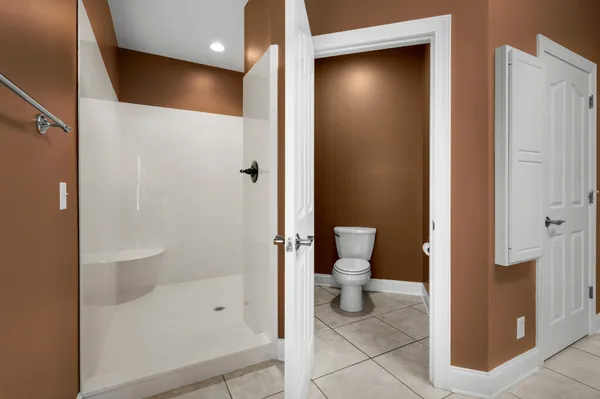 a spacious bathroom with a shower and a sink
