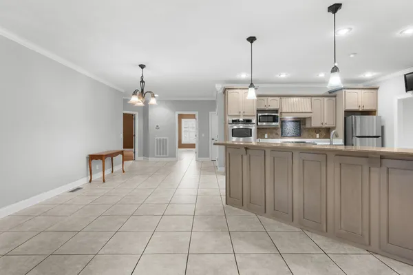 a kitchen with a sink stove and microwave