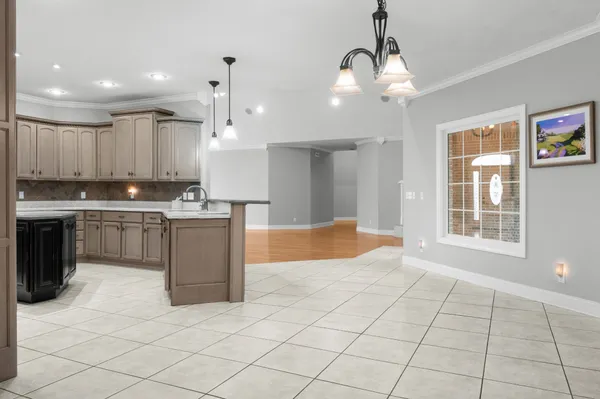 a kitchen with granite countertop cabinets stainless steel appliances and a window